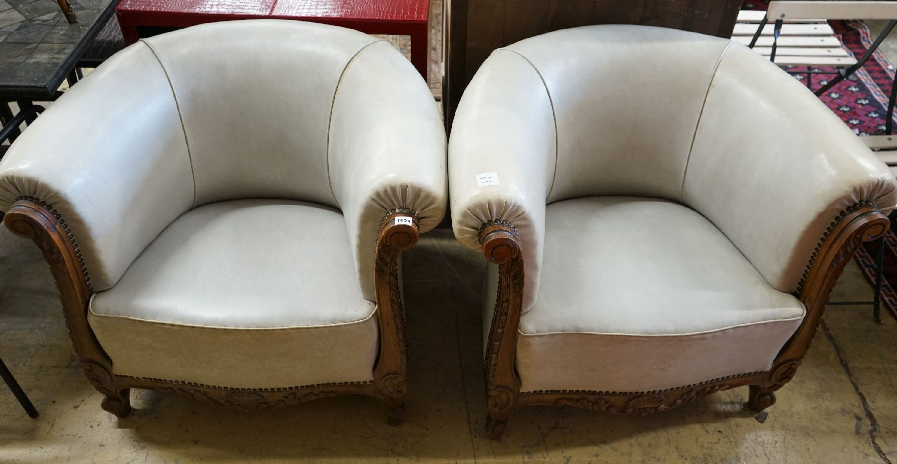 A pair of leather upholstered continental tub chairs, width 88cm, depth 70cm, height 72cm